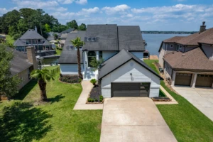 Modern waterfront home where to stay in Montgomery, TX with white garage and lake views