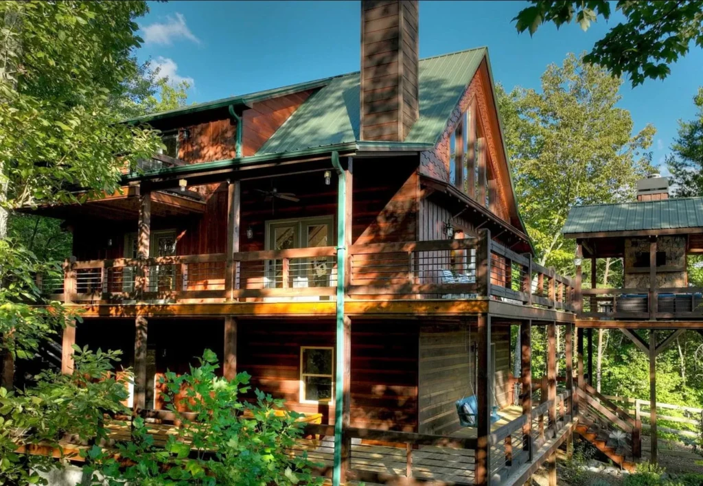 Rustic mountain chalet with red brick exterior and metal roof vacation rental in Blue Ridge, GA