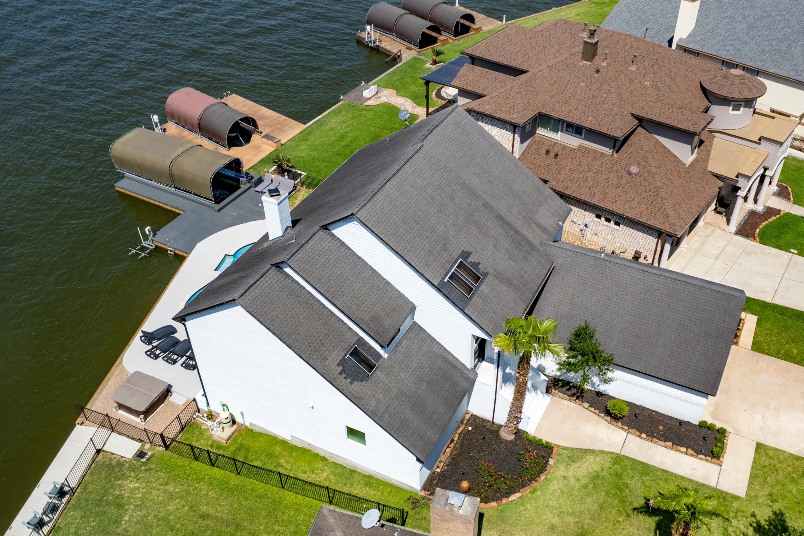 Aerial view of a waterfront home with private dock, one of the Montgomery vacation rentals on Lake Conroe