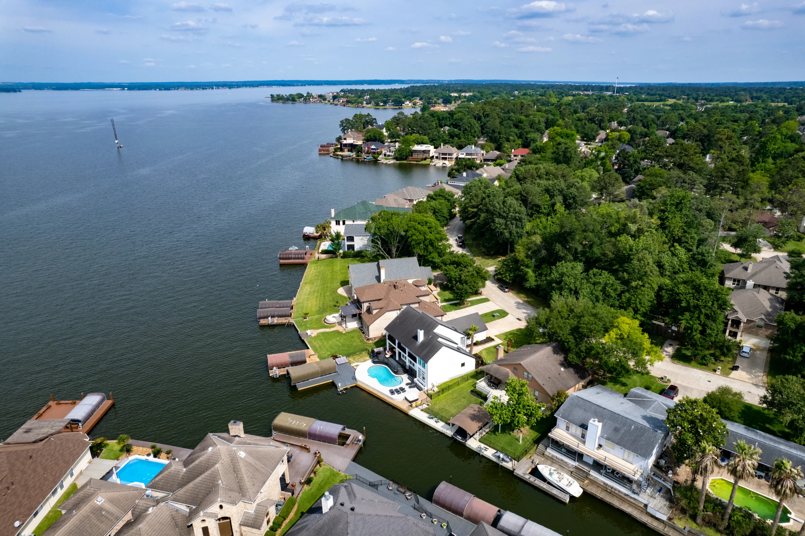 Aerial view of a Lake Conroe villa with pool and dock, a base for the best breakfast Montgomery TX offers